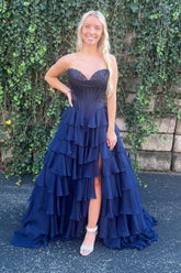 navy blue strapless, tiered, chiffon formal dress with a ruffled neckline